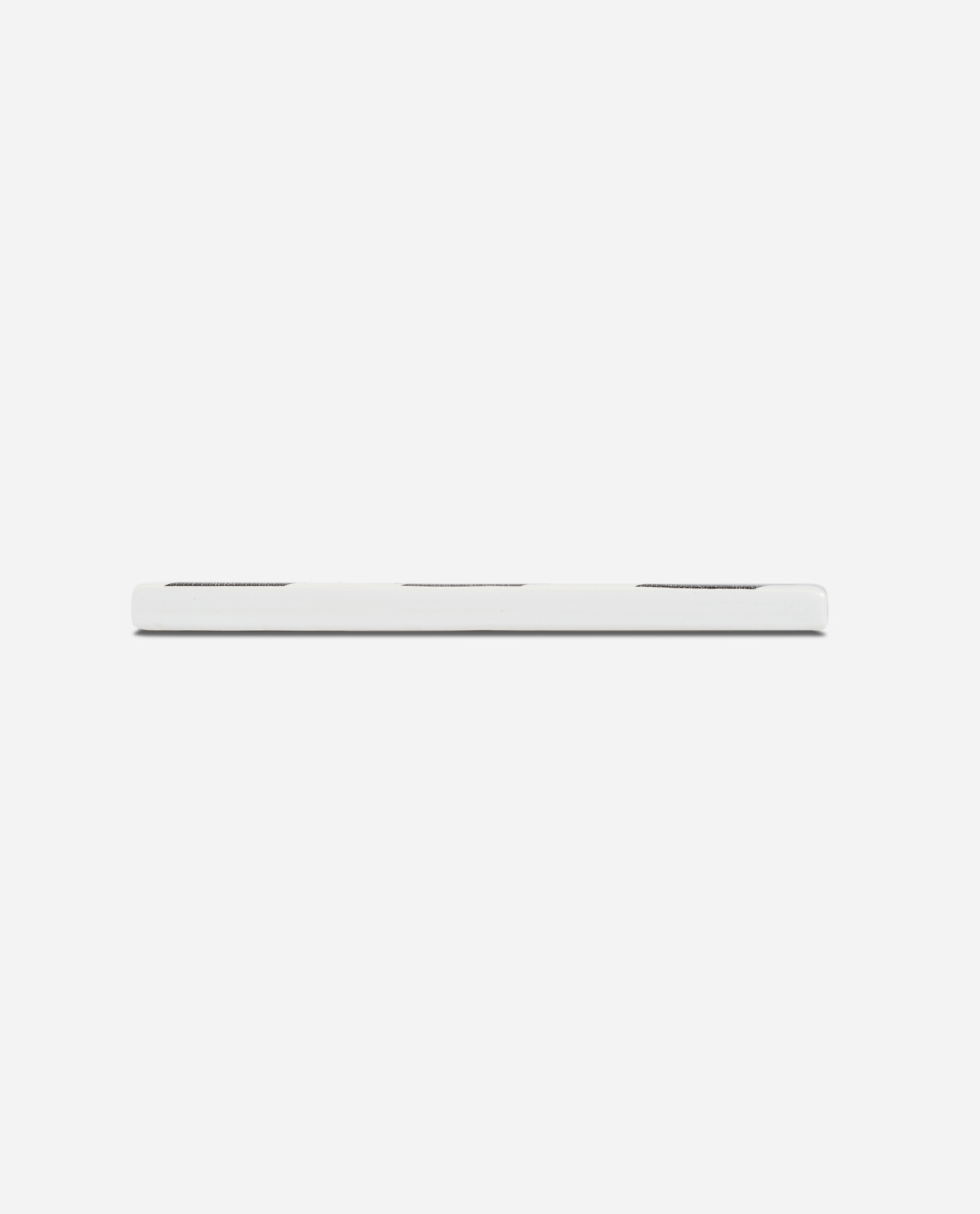 Side profile of Hacienda H ceramic tile showing white edge thickness against neutral background