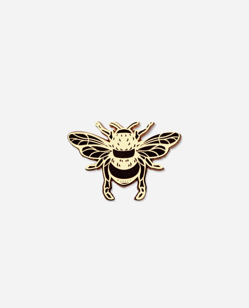 Manchester Bee Pin Badge in gold enamel with black detailing, showing intricate wing veins and striped body, front view