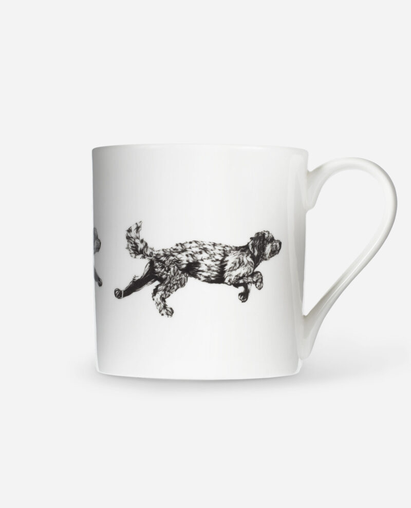 Dog running mug with black cockapoo illustration mid-leap on white bone china, side view showing curved handle