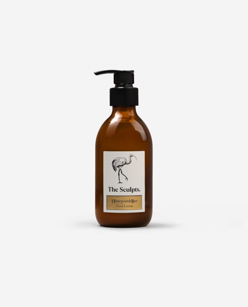 Honeycomb Bee Hand Lotion amber glass bottle with black pump dispenser showing elegant bird illustration and product label